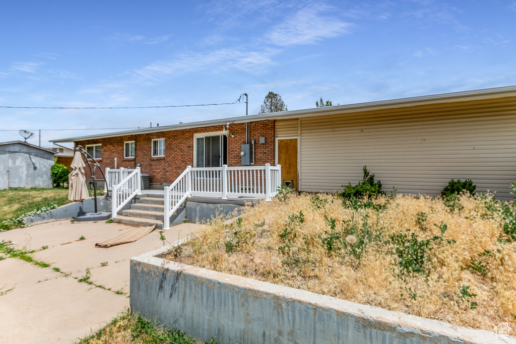 Ranch-style house with a deck and brick siding