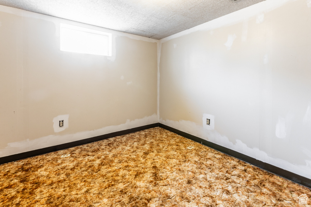 Carpeted spare room with baseboards
