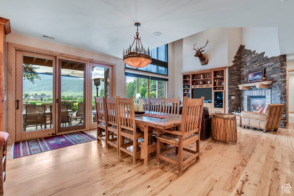 Dining room featuring wood-type flooring and a fireplace