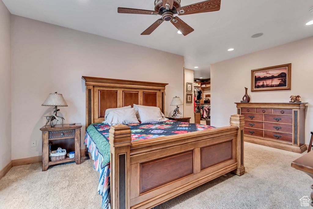 Bedroom featuring light carpet, recessed lighting, ceiling fan, and a spacious closet