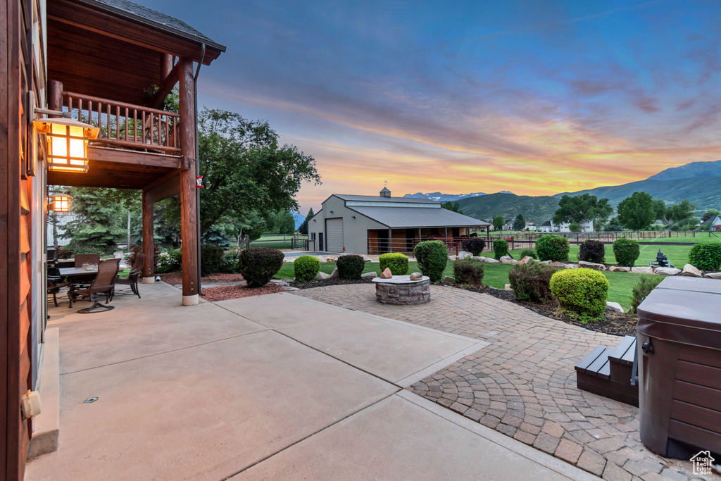 Patio / terrace featuring a mountain view, a patio area, a fire pit, and outdoor dining area