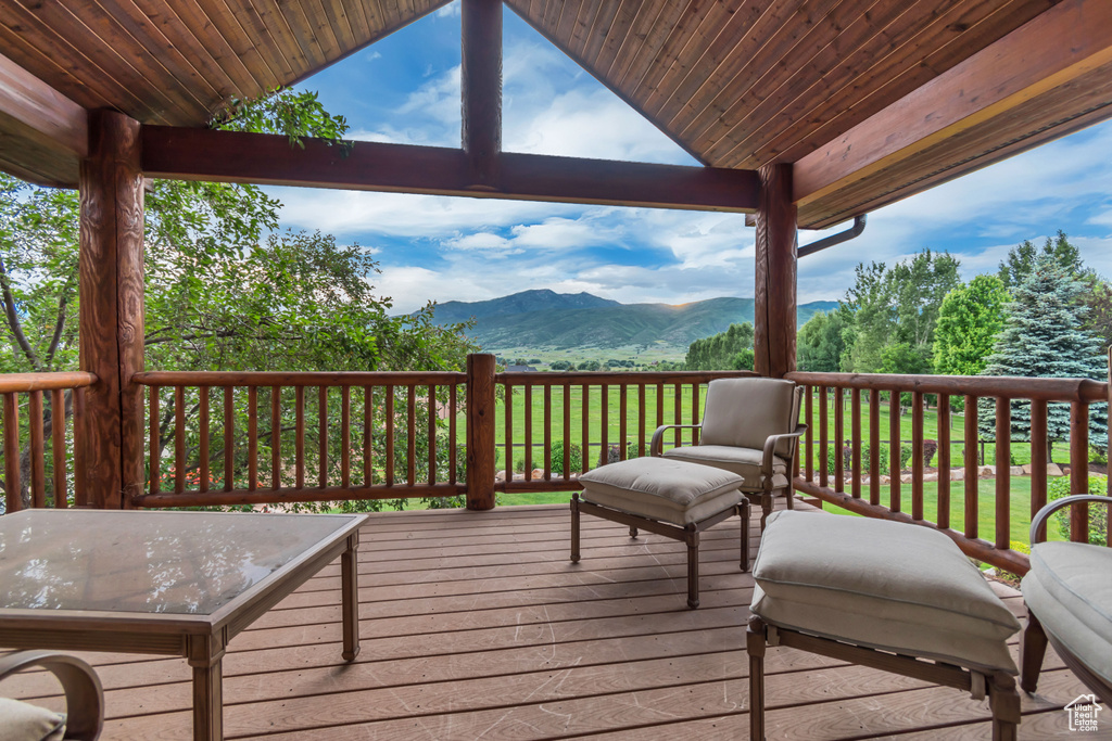 Wooden terrace featuring a mountain view