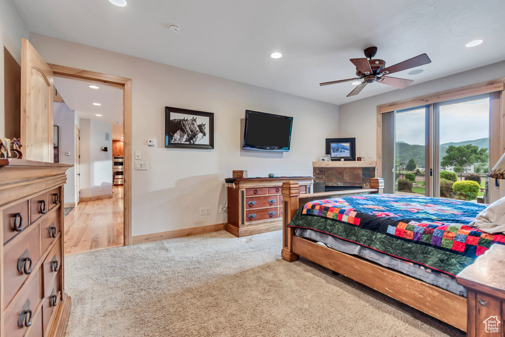Bedroom featuring light carpet, recessed lighting, and a ceiling fan
