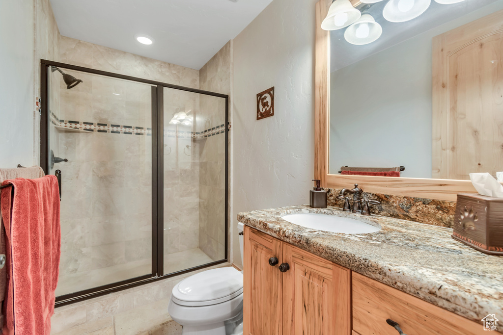 Full bathroom featuring vanity and a shower stall