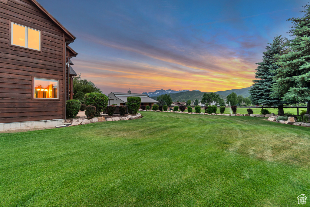 View of grassy yard featuring a mountain view