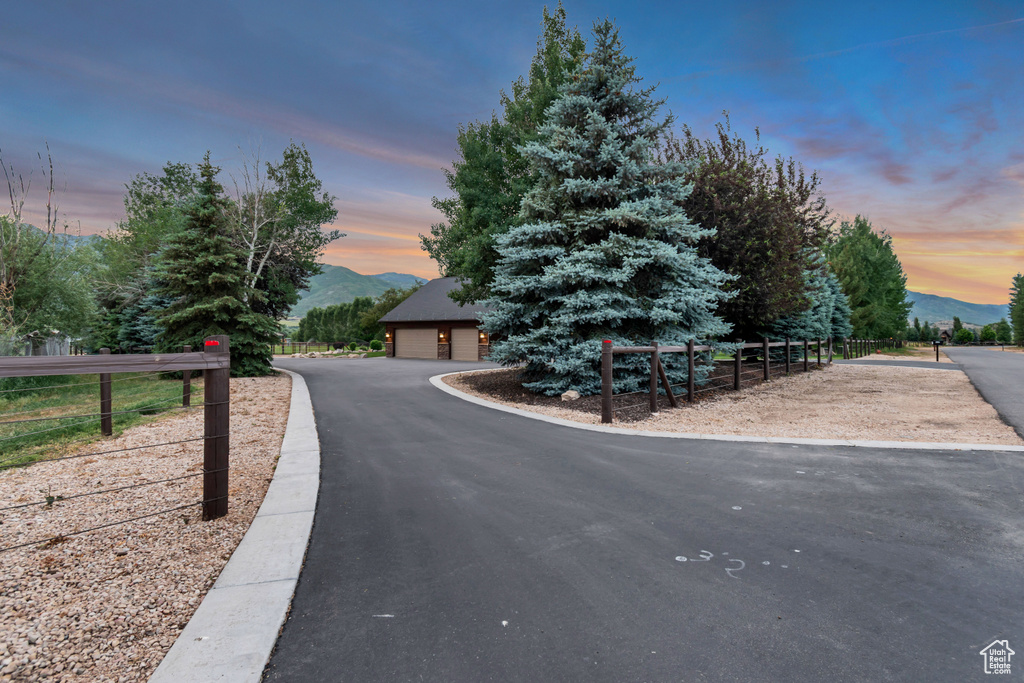 Obstructed view of property with a mountain view and a garage