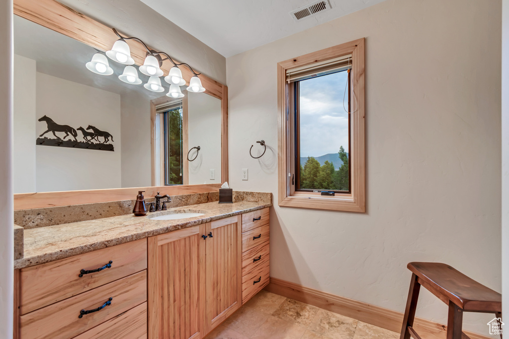 Bathroom with vanity and healthy amount of natural light