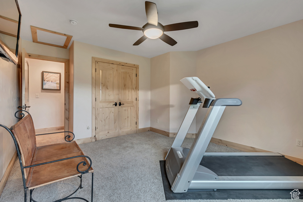 Exercise area with carpet floors and ceiling fan