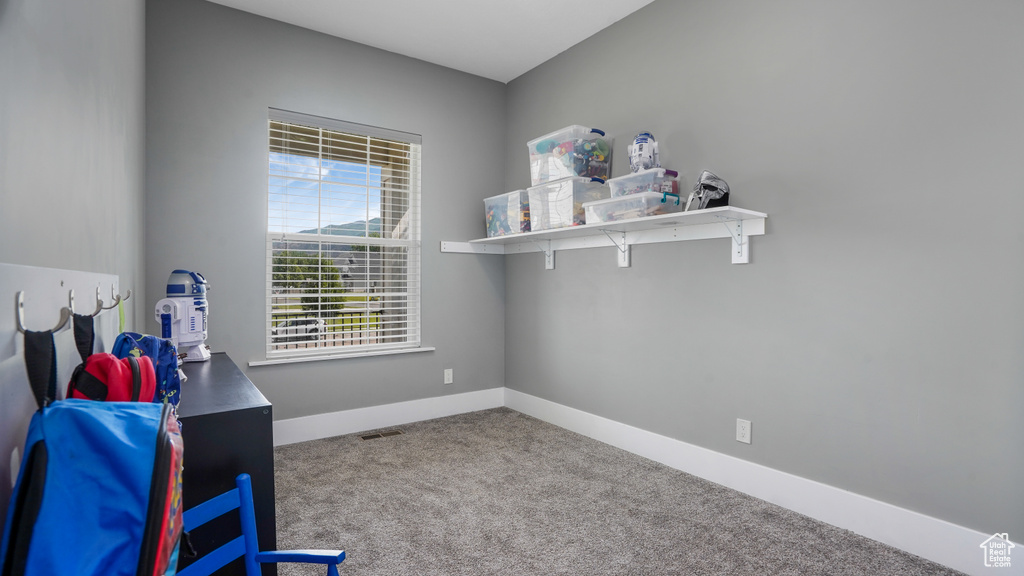 Carpeted office space with baseboards