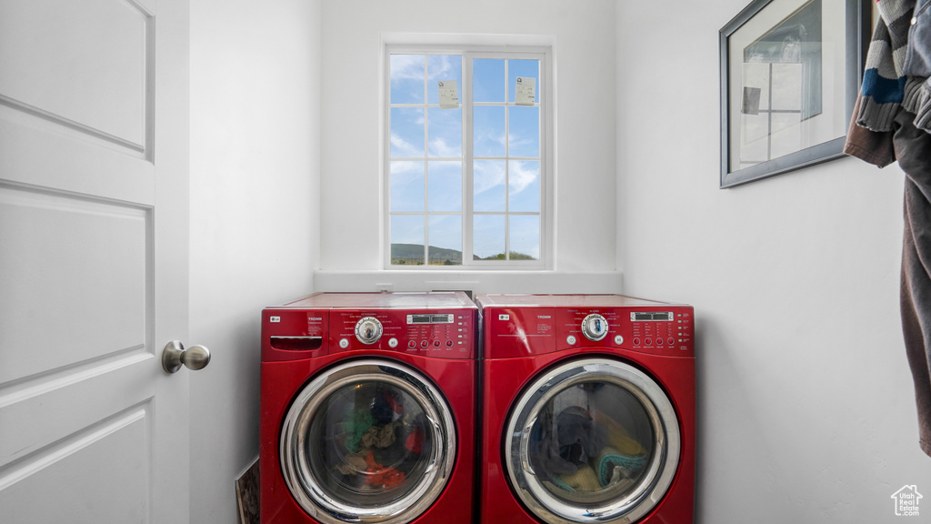 Laundry area featuring washing machine and dryer and plenty of natural light