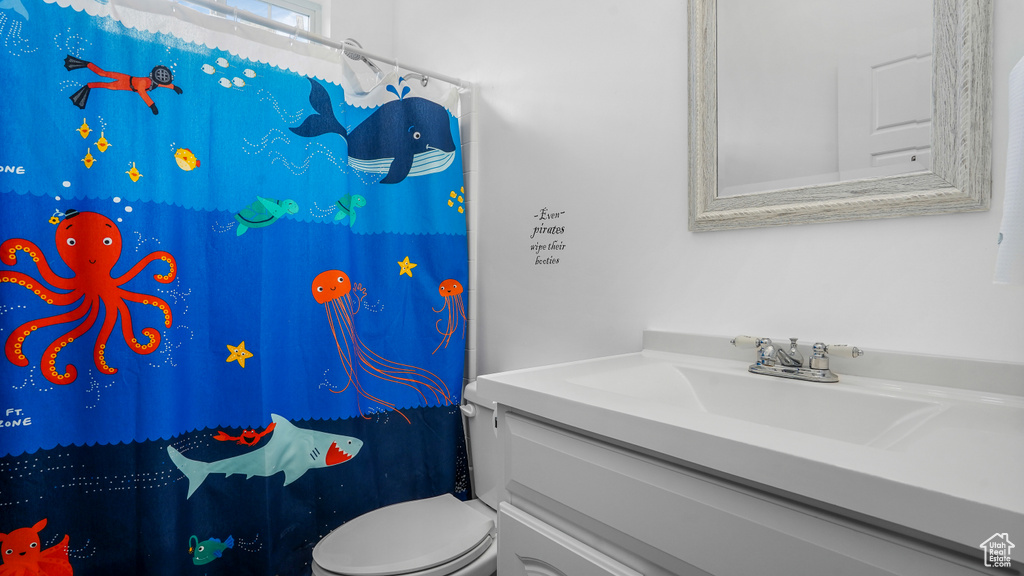 Bathroom with vanity and a shower with shower curtain