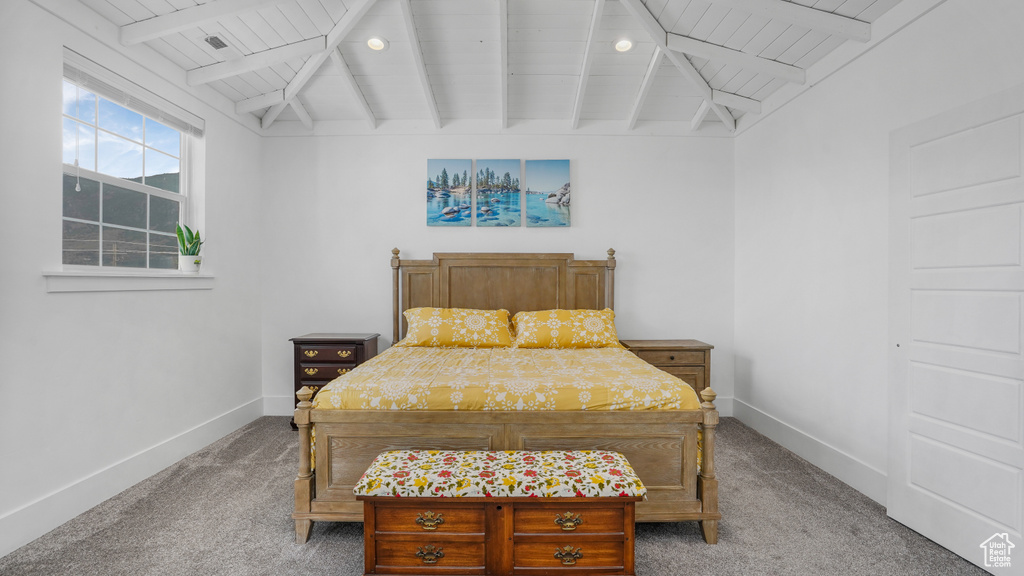 Carpeted bedroom with wooden ceiling and baseboards