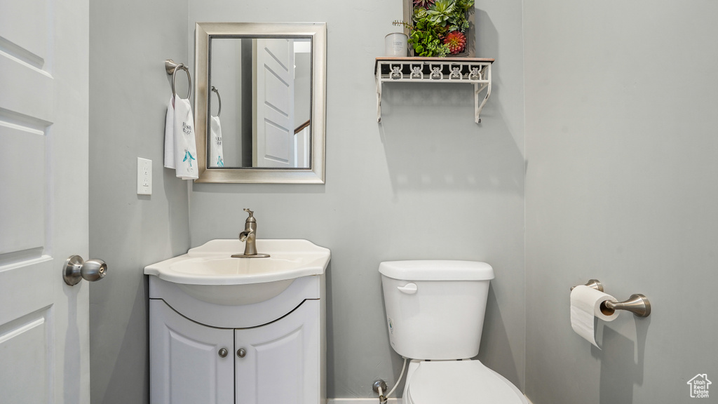 Half bathroom with toilet and vanity