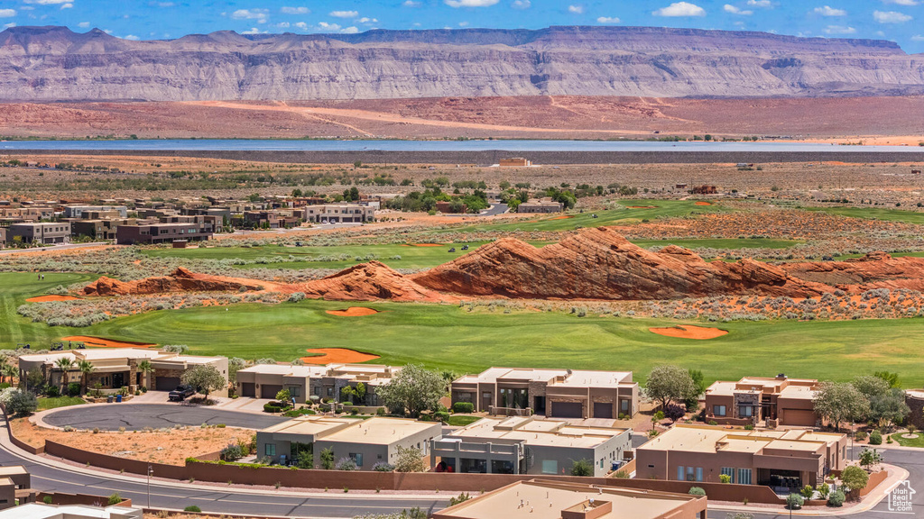 View of mountain background with a nearby body of water and a local golf course