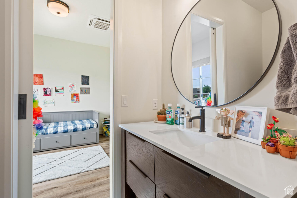 Bathroom featuring vanity and wood finished floors