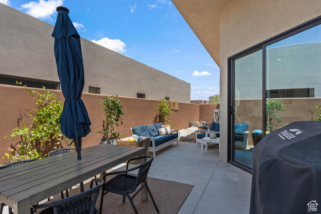 View of patio with an outdoor living space, a grill, and outdoor dining area