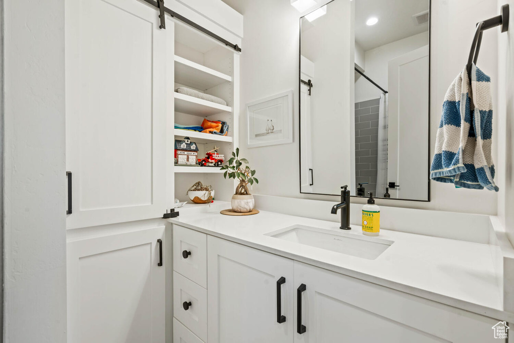 Full bath featuring vanity and a shower