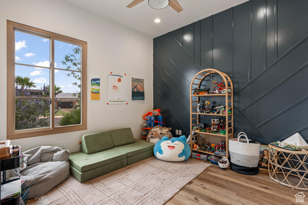 Playroom featuring plenty of natural light, ceiling fan, wood finished floors, and recessed lighting