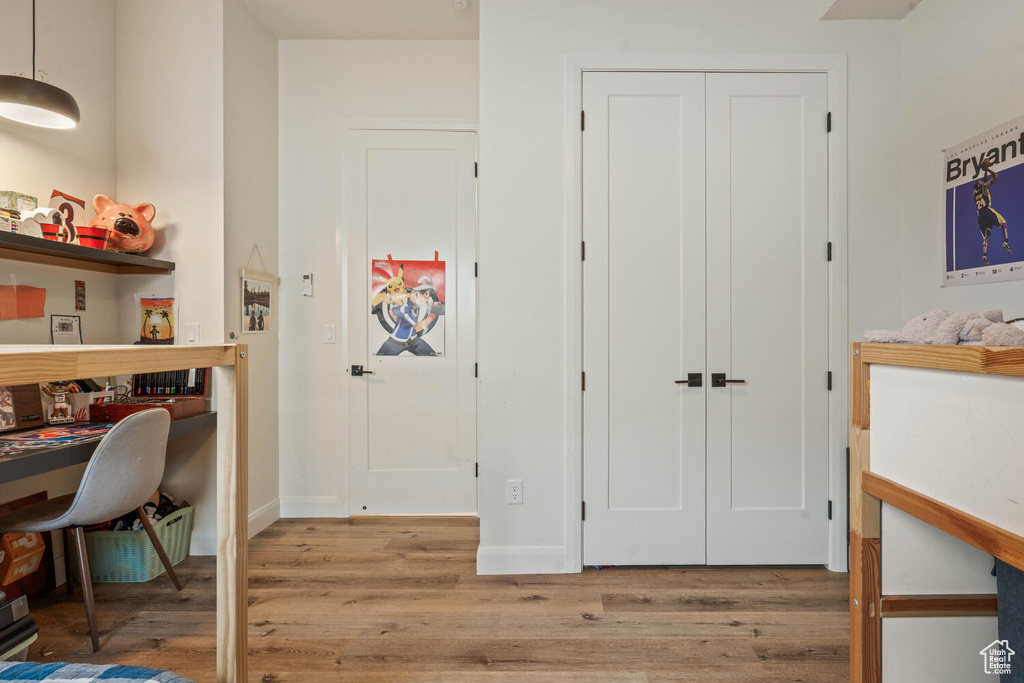 Home office with wood finished floors and baseboards