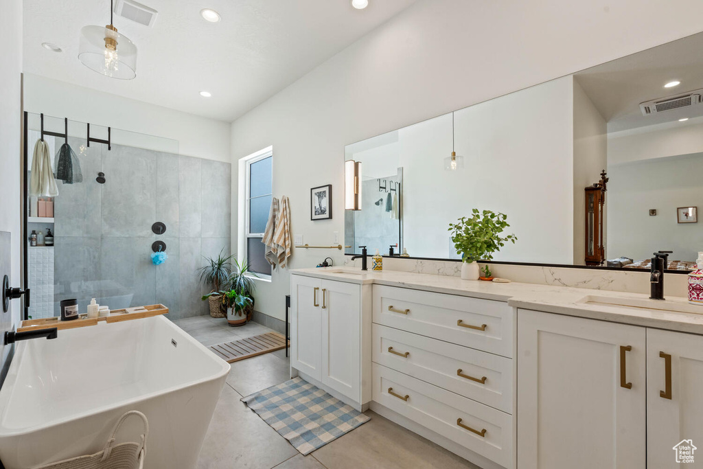 Full bath with vanity, a soaking tub, a tile shower, recessed lighting, and tile patterned floors
