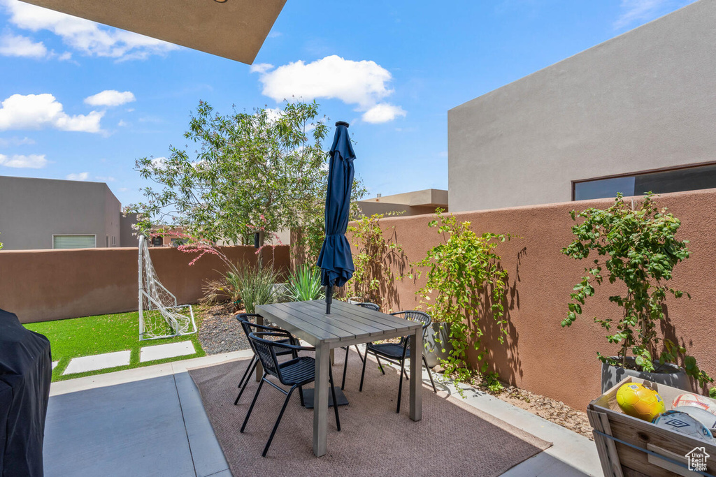Fenced backyard with outdoor dining space and a patio area