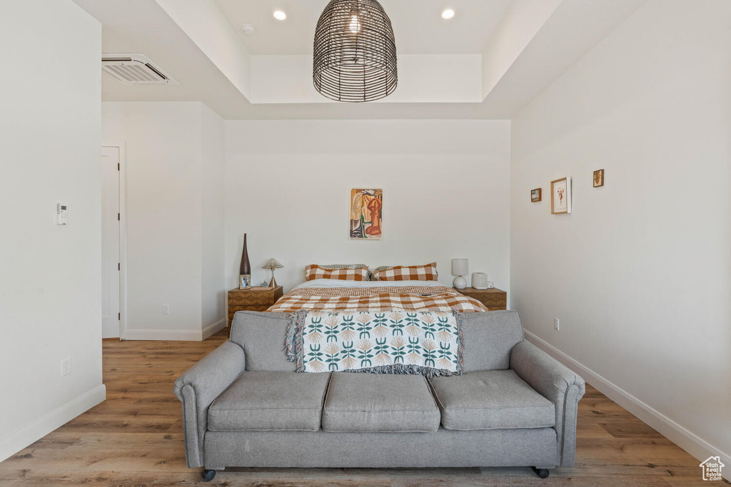 Bedroom with wood finished floors and recessed lighting