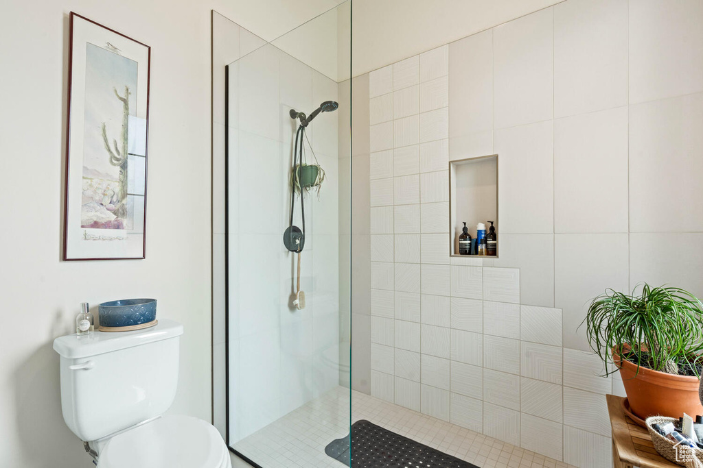 Bathroom with tiled shower and toilet