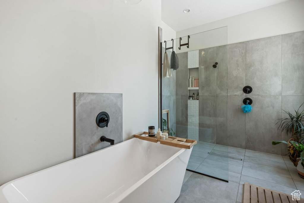 Full bathroom featuring a soaking tub and a walk in shower