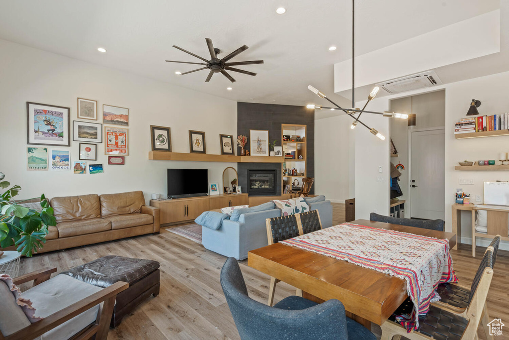 Dining area with light wood-style flooring, ceiling fan, and recessed lighting