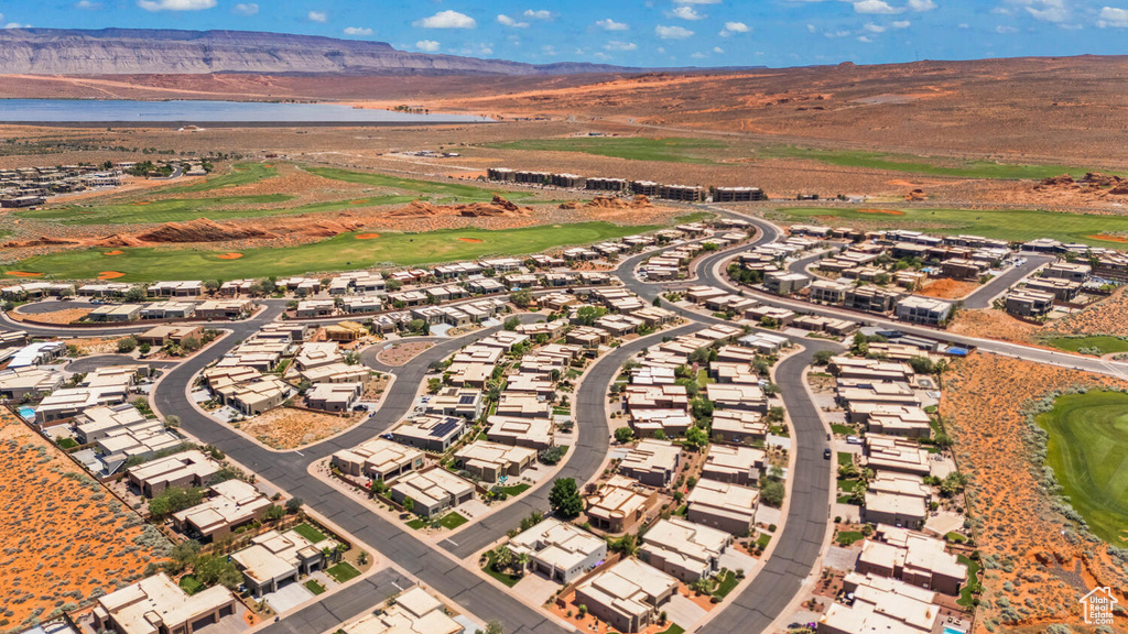 Aerial view of residential area featuring a water and mountain view and a local golf course
