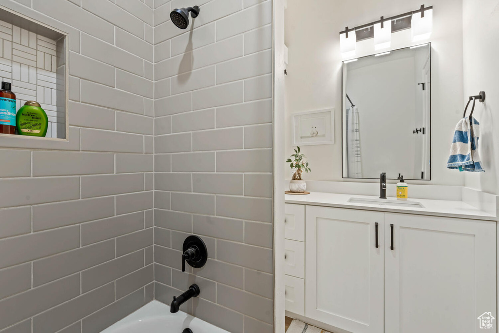 Bathroom with vanity and shower / washtub combination