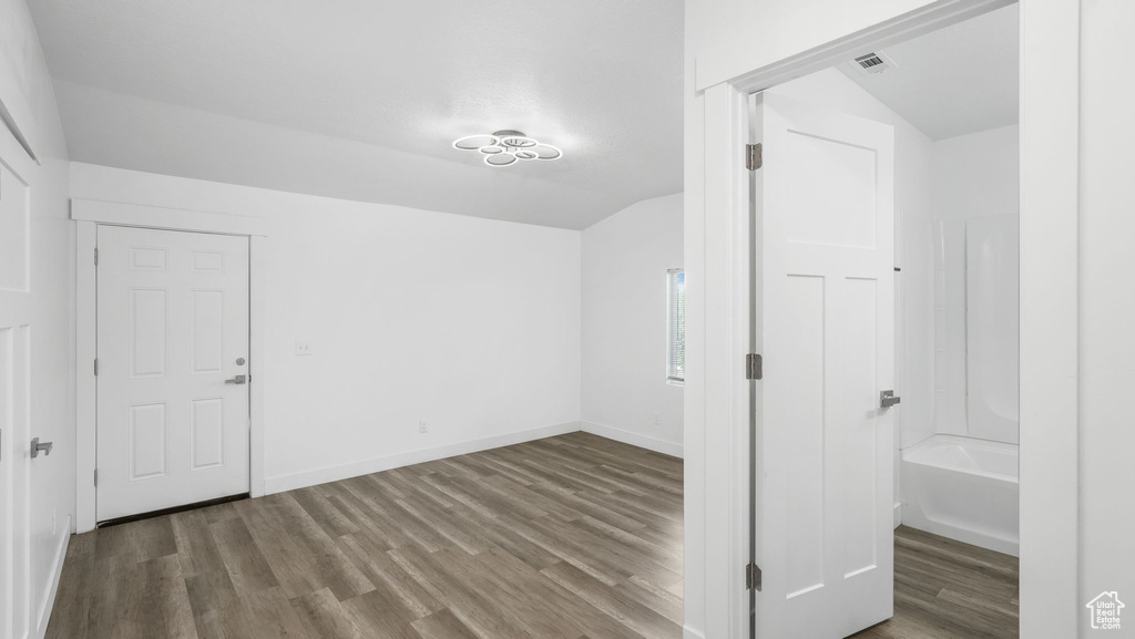 Bonus room featuring wood finished floors and baseboards