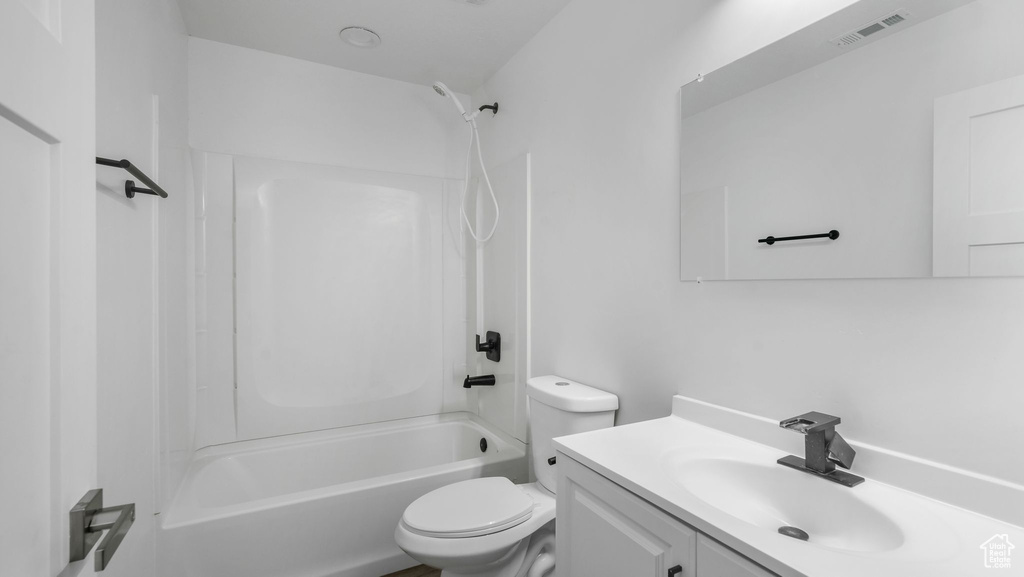 Bathroom featuring vanity and washtub / shower combination