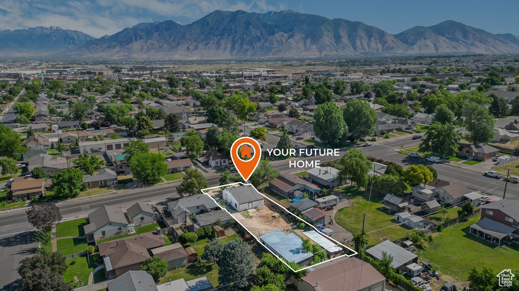Aerial view of residential area featuring mountains and property boundaries highlighted