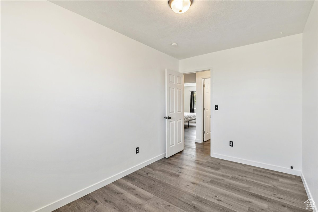 Unfurnished room featuring baseboards and light wood finished floors