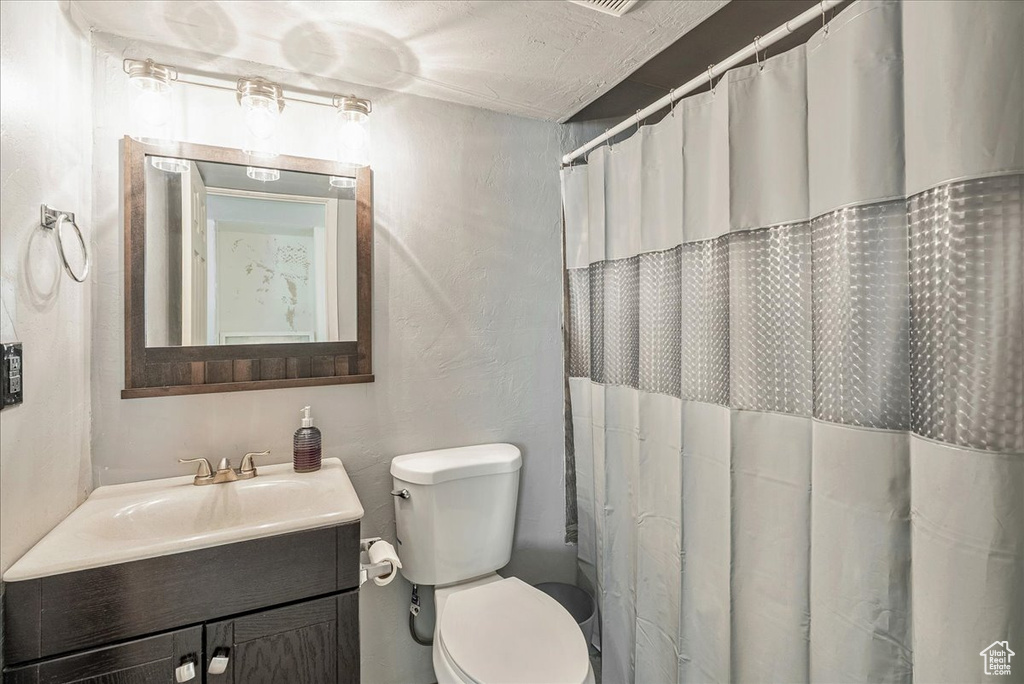 Full bath featuring vanity and a shower with shower curtain