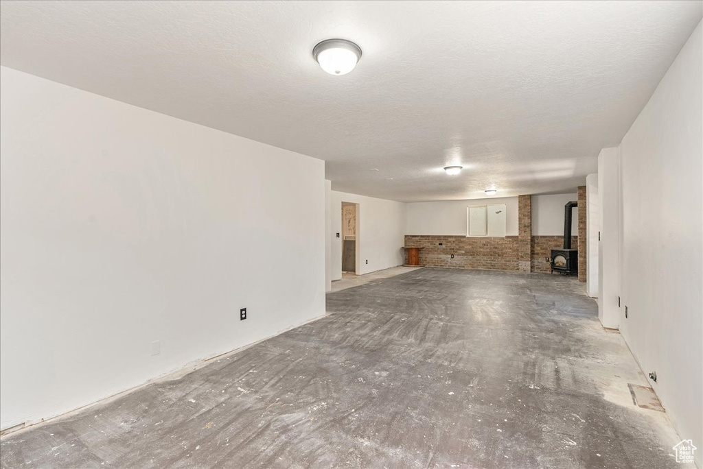 Unfurnished living room with a wood stove