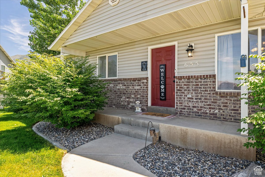 Entrance to property featuring brick siding