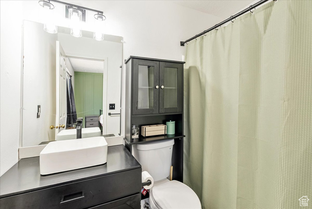 Full bath with vanity and a shower with curtain