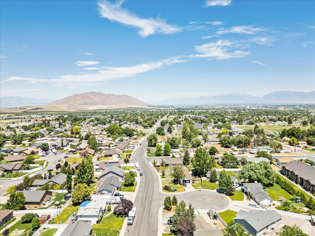Aerial perspective of suburban area with a mountainous background