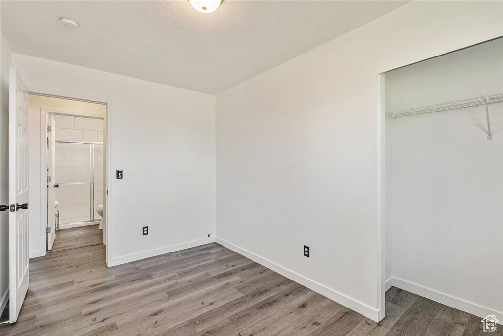 Unfurnished bedroom with light wood-style flooring and a closet