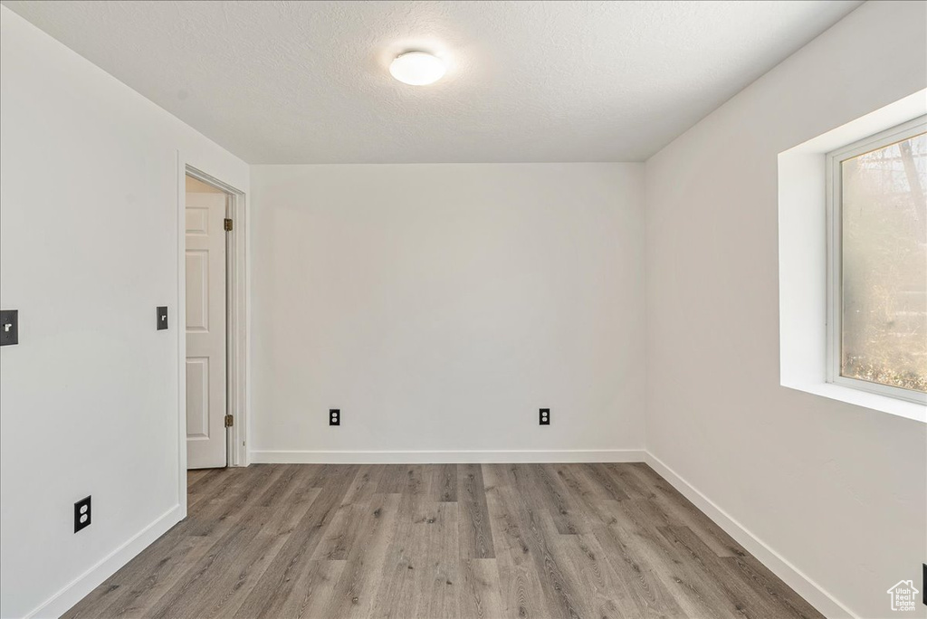 Unfurnished room featuring wood finished floors and baseboards