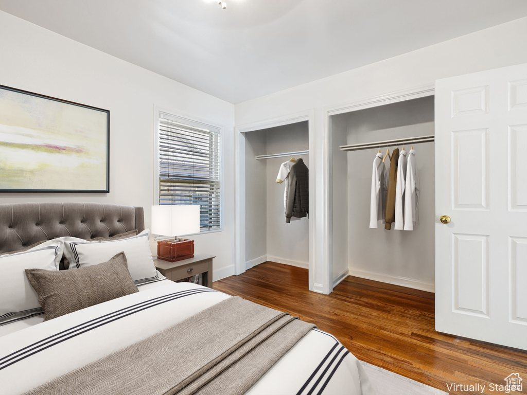 Bedroom featuring two closets and wood finished floors