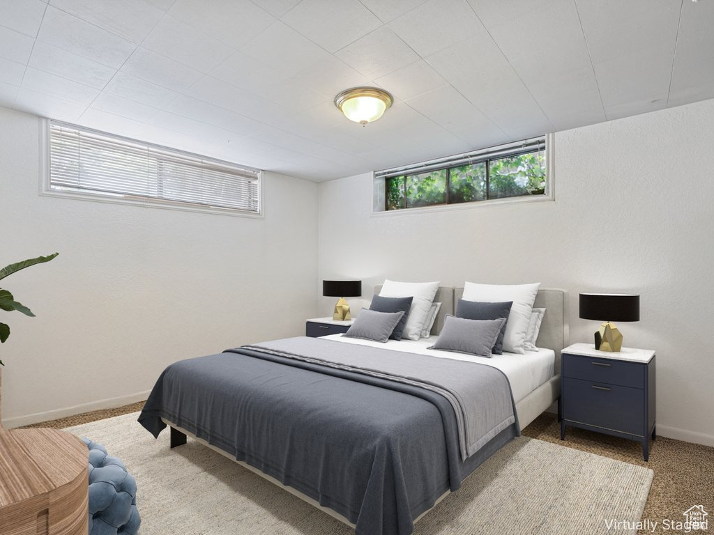 Bedroom with multiple windows and light colored carpet