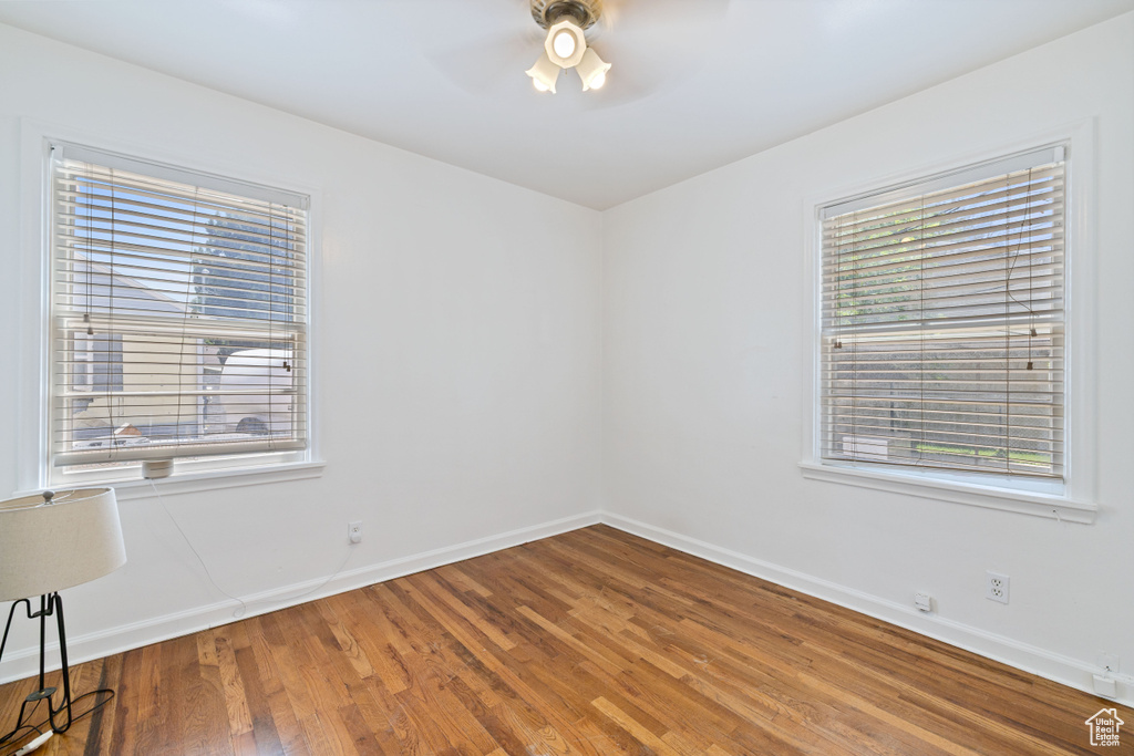 Empty room featuring a ceiling fan and wood finished floors