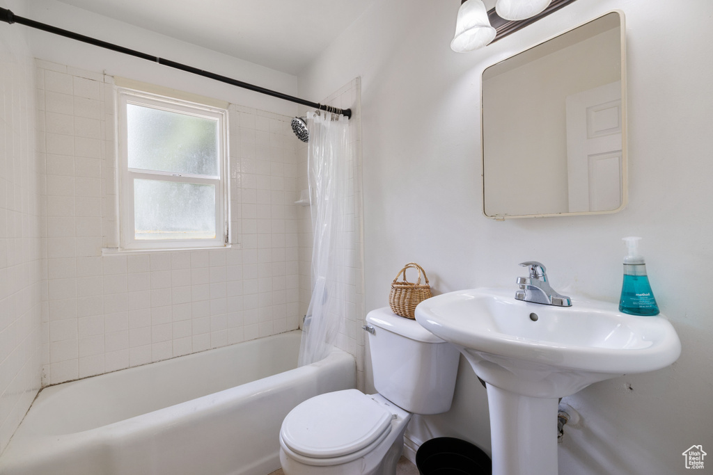 Full bathroom with toilet and shower / bath combo