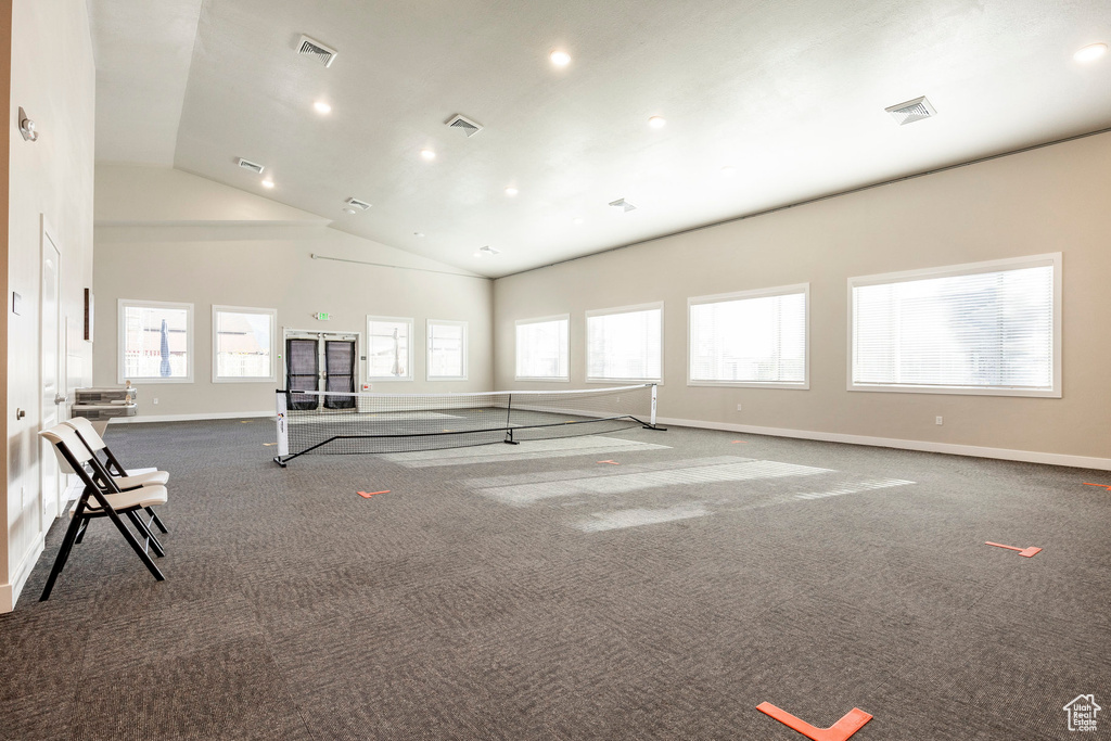 Carpeted spare room with recessed lighting and high vaulted ceiling