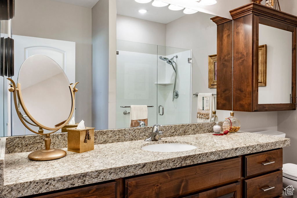 Full bath with a shower stall and vanity