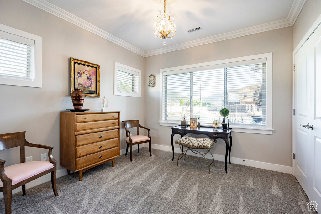 Carpeted office featuring ornamental molding and a chandelier