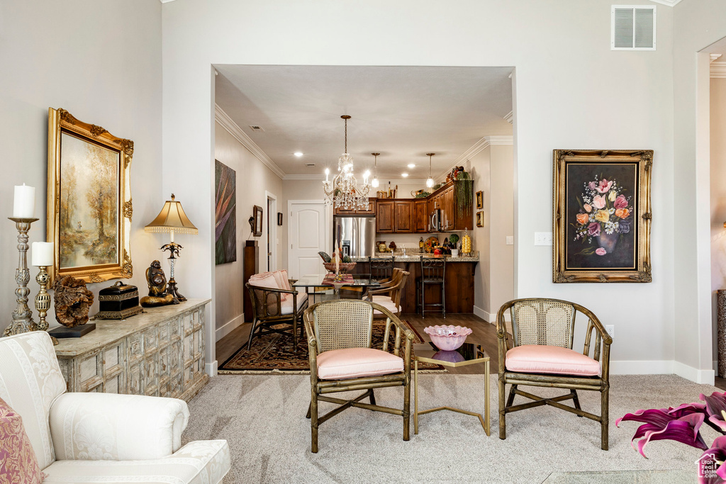 Living room with crown molding and a chandelier